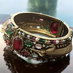 A beautiful Sabyasachi inspired Crocodile designs American diamond openable bracelet with gold finish and  Ruby red and Precious multicolor stones fit for 2.4,2.6 size . Elegant Red Kundan Bracelet, Ceremonial Red Kundan Bracelets, Ceremonial Red Cutdana Bangle, Ceremonial Ruby Bangle Jewelry, Luxury Ruby Bangle, Jewelry Victorian, Bangles Indian, American Diamond, Bracelet Gold