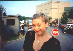 a woman standing in front of a stop sign