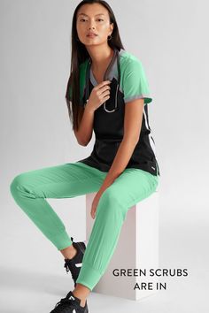 Female medical professional sitting on a stool wearing the Grey's Anatomy™ by Barco Spandex STRETCH Women's 3-Pocket Color Block V-Neck Scrub Top and the Spandex STRETCH Eden Women's 5-Pocket Cargo Jogger Scrub Pants. Greys Anatomy Scrubs, Flexible Stretches, Uniform Advantage, Scrubs Uniform, Medical Uniforms, Scrub Sets, Cargo Joggers, Fresh Mint, Scrub Pants