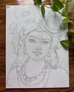 a pencil drawing of a woman's face on a piece of paper next to a plant