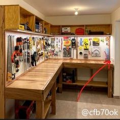 a workbench filled with lots of tools and magnets on the wall next to it