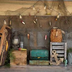 there are many items on the shelf next to each other, including fishing nets and buckets