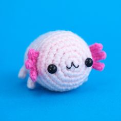 a crocheted toy with a pink bow on it's head and eyes