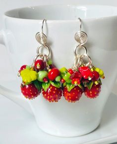 These Bowl Full of ... Strawberries earrings are whimsical chic! They feature artisan, handmade glass berries, glass flowers, leaves and other glass lovelies they are paired with silver/copper wire and ear wires. The colorful fun of these statement earrings make them a one of a kind find. Whimsical Czech Glass Jewelry With Ear Wire, Whimsical Czech Glass Jewelry Set With Earrings, Red Whimsical Nickel-free Earrings, Whimsical Red Nickel-free Earrings, Whimsical Red Jewelry With Matching Earrings, Handmade Fun Sterling Silver Jewelry, Whimsical Handmade Red Earrings, Whimsical Multicolor Sterling Silver Jewelry, Whimsical Multicolor Wire Wrapped Jewelry