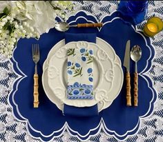 a blue and white place setting with silverware