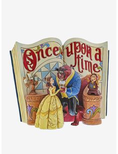 an open book with the words once upon a time written on it and disney characters