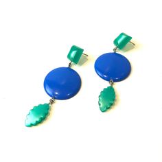 Cornflower blue meet emerald green geometric shapes cascade in these elegant and retro-vibe statement earrings. Each earring measures just about 3" length & are super light weight. Earrings are made with mostly vintage lucite parts that were made in the US in the 1960's - early 80's. We hand-set them with surgical steel earring posts and they have sturdy surgical steel/acrylic backings on them as well. Surgical Steel Earrings, Moon Glow, Earring Posts, Vintage Lucite, Cornflower Blue, Light Weight Earrings, Retro Vibe, Emerald Green, Post Earrings