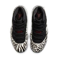 The Nike Women’s Air Jordan 11 Retro 'Animal Instinct' takes Tinker Hatfield's original 1995 design and gives it a wildlife-inspired makeover. The mid-top's signature patent leather overlay is replaced by a furry ivory-colored overlay, finished in a medley of cheetah, leopard and zebra prints in black. The rest of the upper is constructed from black nubuck with tonal webbing lace loops and a raised Jumpman logo on the lateral ankle. Contrasting crimson accents settle on the stylized '23' printed Jordan Women, Animal Instinct, Jordan Model, Nike Air Jordan 11, Jumpman Logo, Womens Air Jordans, Jordans Women, Retro 1, Air Jordan 11 Retro