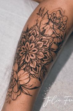 a woman's leg with flowers on it