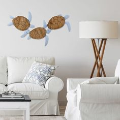 a living room with two white couches and a coffee table