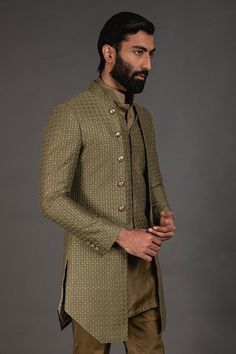 Olive green front open achkan with embroidered detail and full sleeves. Paired with shirt style kurta and lounge pant.
Component: 3
Pattern: Embroidered
Neckline: Mandarin
Sleeve Type: Full Sleeves
Fabric: Chanderi Silk, Cotton Silk
Color: Green
Other Details: 
Silk thread work
Front buttons
Printed lining
Note: Waistcoat worn by the model is not for sale
Occasion: Sangeet - Aza Fashions Traditional Zari Work Sets For Semi-formal Occasions, Designer Sets With Resham Embroidery And Long Sleeve, Designer Green Kurta For Festive Occasions, Designer Long Sleeve Sets With Resham Embroidery, Designer Nehru Jacket With Long Sleeves For Diwali, Formal Green Kurta With Chikankari Embroidery, Designer Long Sleeve Nehru Jacket For Diwali, Green Formal Traditional Wear With Naqshi Embroidery, Green Naqshi Traditional Wear For Formal Occasions