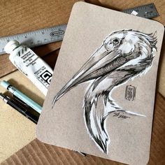 a drawing of a pelican on a piece of paper next to some markers