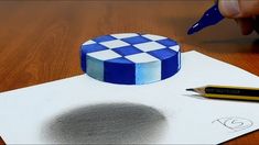 a blue and white checkerboard design on paper next to a fountain pen,