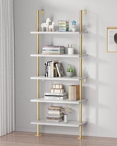 a white and gold book shelf with books on it