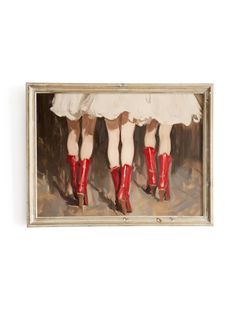 three women in red boots and white dresses are standing together, with their legs crossed