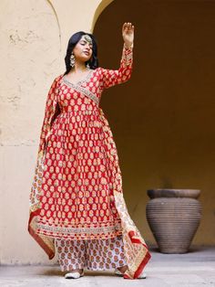 Red Angrakha Anarkali Kurti with palazzo and chanderi dupatta, has a v-neck and full-length sleeves, embellished with hand block printing work all over. Neck: Angarakha Neck Sleeve Length: 3/4th Sleeve Kurta Length: Ankle Length Fabric: Kurta & Bottom - Cotton Dupatta - Chanderi Note: Wash Care Instructions - Dry Clean Only. The product will be shipped within 15-20 days of the order placed Measurements: Size Bust Waist Hip XS 34 28 36 Size 36 30 38 M 38 32 40 L 40 34 42 XL 42 36 44 2XL 44 38 46 Chanderi Palazzo Set With Resham Embroidery And Long Sleeves, V-neck Anarkali Set For Diwali, Festive Chanderi Salwar Kameez With V-neck, Anarkali Palazzo Set With Zari Work And Long Sleeves, Long Sleeve Lehenga With Gota Work For Eid, Traditional V-neck Set With Resham Embroidery, Anarkali Kurta With Gota Work And Long Sleeves, Anarkali Long Sleeve Kurta With Gota Work, Festive Salwar Kameez With Gota Work And Long Sleeves