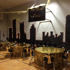 tables and chairs are set up in the middle of a room decorated with gold sequins