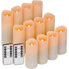 eight white candles with remote controls in front of them