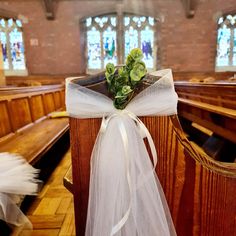 a white ribbon tied to the pews in a church