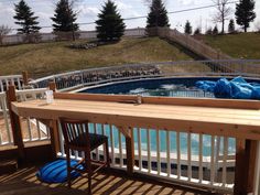 an above ground swimming pool in the middle of a deck