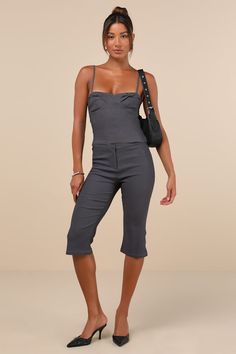 Everyone will envy your oh-so-chic look when you're wearing the Motel Sawil Charcoal Grey Mid-Rise Capri Trouser Pants! Stretchy woven fabric shapes these on-trend pants that have a mid-rise fit with a banded waist and a hidden zip fly with a top clasp closure. Fitted legs continue down to chic, capri-length hems with a slight flare. Pair with the matching top for a complete look! Fit: This garment fits true to size. Length: Knee Length. Size medium Inseam: 17.50 Front Rise: 9.00 Waist: Fitted - Fitted Cropped Bottoms With Pockets, Chic Capri-length Pants, Fitted Workwear Capri Pants, Fitted Capri Length Work Pants, Fitted Capri Length Pants For Work, Chic Capri Pants With Pockets, Chic Cropped Bottoms With Pockets, Fitted Capri Length Bottoms For Work, Elegant Fitted Capri Length Pants