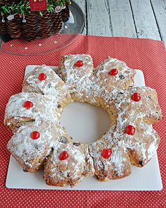 a white plate topped with a pineapple bundt cake covered in powdered sugar