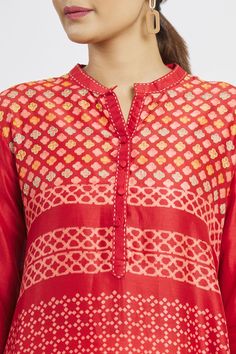 Red asymmetric chanderi tunic with floral  and geometric block print and placement embroidery.
Component: 1
Pattern: Printed
Type Of Work: Floral
Neckline: Mandarin
Sleeve Type: Three Quarter Sleeves
Fabric: Chanderi
Color: Red
Other Details: 
Block print
Note: Pant worn by the model is not for sale
Occasion: Puja,Work - Aza Fashions Geometric Block Print, Placement Embroidery, Asymmetric Tunic, Tunics Online, Kurti Neck, Kurti Neck Designs, Womens Tunics, Mandarin Collar, Festival Wear