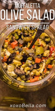 a glass bowl filled with olives and vegetables