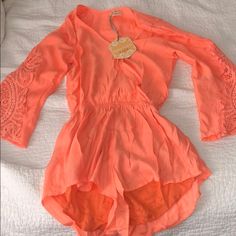 New With Tags!! Bright Coral Orange Romper. Flowy Crochet Sleeves. The Bottom Is Lined, So It’s Not See Through. There’s A Snap To Make It Not As Low V Neck. Perfect Light Romper For Summer! Purchased From Showpo Size 6 Or Small Orange Stretch Jumpsuits And Rompers For Spring, Summer Fitted Long Sleeve Jumpsuits And Rompers, Fitted Long Sleeve Summer Jumpsuits And Rompers, Fitted Long Sleeve Summer Jumpsuit, Orange Long Sleeve Jumpsuits And Rompers For Summer, Dance Jumpsuit, Orange Romper, Crochet Sleeves, 2024 Clothes