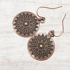 Richly Detailed Copper Mandala Dangle Earrings are inspired by the beauty of mandala patterns. These antique copper finish earrings are the perfect blend of artistic flair and elegance.  Incredibly versatile, complementing any outfit from casual to formal. Their lightweight design ensures comfortable wear all day long, making them your go-to earrings in your jewelry collection. Elevate your style and add a touch of sophistication with these must-have earrings. Hypoallergenic ear wires (nickel an Bohemian Sun Design Adjustable Earrings, Copper Drop Earrings For Festivals, Copper Drop Earrings For Festival, Bohemian Sun Design Drop Earrings, Bohemian Sun Design Earrings For Festival, Bohemian Dangle Earrings With Sun Design, Bohemian Sun Design Dangle Earrings, Detailed Mandala, Mandala Patterns