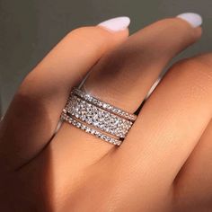 a woman's hand with two rings on it