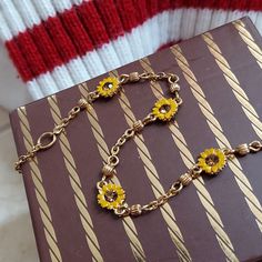 Sweet Sunny Bracelet. A classic to layer your way. 1990's Faux topaz stones, framed within yellow daisy petals. Delicate golden chain accented in fluted beads. Appears to be magnetic. Gleaming gold tone metal. (Not karat gold). This is a small size at 7.5 inches. Lobster clasp. Gift boxed. VINTAGE Retro Gold Jewelry With Adjustable Chain, Retro Yellow Gold Metal Jewelry, Retro Jewelry With Adjustable Chain, Retro Necklace With 17 Jewels For Gift, Yellow Chain Jewelry As Gift, Vintage Adjustable Chain Jewelry, Adjustable Vintage Chain Jewelry, Adjustable Vintage Style Chain Jewelry, Vintage Bracelets With Adjustable Chain