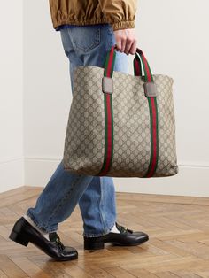 The monogram decorating Gucci's 'GG Supreme' coated-canvas is one of fashion's most recognisable hallmarks. Crafted in Italy, this tote bag is made from monogrammed 'Tender' canvas trimmed with signature red and green webbing. Store your essentials in the handy internal zip pocket. Luxury Bag Men, Beige Tote Bag, Beige Tote, Shopping Totes, Gucci Tote Bag, Men's Totes, Gucci Tote, Gucci Accessories, Gucci Men