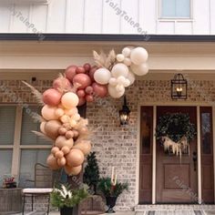 a bunch of balloons hanging from the side of a house