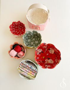 four different types of fabric in small containers