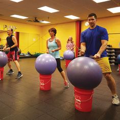 a group of people doing exercises with exercise balls