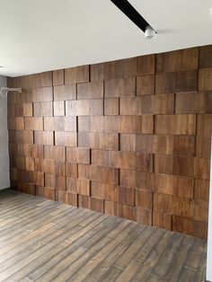 an empty room with wood panels on the wall