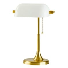 a gold and white lamp on a white background