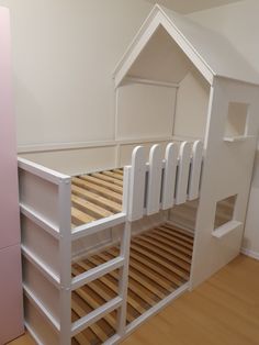 a white bunk bed with wooden slats