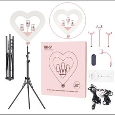 two heart shaped lights are on a tripod next to an electronic device and other accessories