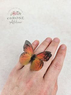 This butterfly ring who beautifully captures the magic of nature is an outfit changer and a real eye-catcher. Looks gorgeous with anything! Handcrafted from soft natural silk, this ring features a beautiful butterfly that will brighten up your look. The base of the ring is adjustable, so it will fit any finger size. Product specifications:     * handmade of silk;     * wingspan is about 5 cm     * adjustable size;     * the butterfly has two layers of silk;     * realistic look. Due to the prope Unique Handmade Butterfly Ring, Bohemian Butterfly Ring As Gift, Bohemian Butterfly Ring As A Gift, Handmade Butterfly Rings For Wedding, Handmade Butterfly Wedding Rings, Handmade Butterfly Shaped Wedding Rings, Organza Butterfly, Gothic Gifts, Orange Butterfly