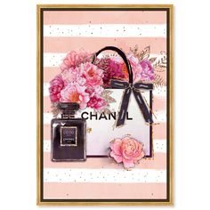 a chanel bag with flowers on it and a bottle of perfume next to it