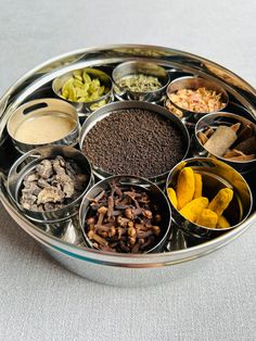 a metal tray filled with lots of different types of spices