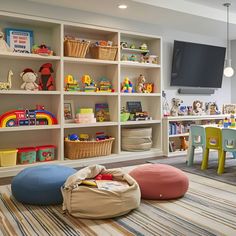 a child's playroom with toys and bookshelves