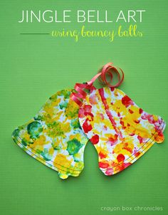 two paper flowered bibs hanging on a green background with the title, jungle bell art using pony tails