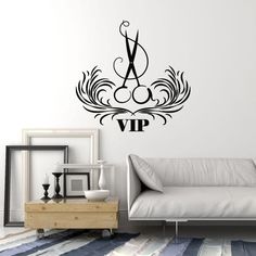 a living room with a white couch and black wall decal that says vap