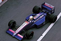 a man driving a racing car down a race track