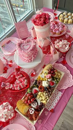 a table topped with lots of cakes and desserts