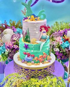 the little mermaid cake is decorated with fondant and seaweed for an under the sea theme