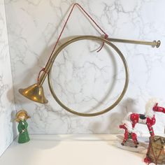 two toy figurines are sitting on a counter next to a wall mounted instrument